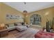 Inviting living room with large window, sectional sofa, and decorative accents at 850 Van Gogh Road, Englewood, FL 34223