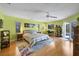 Bright main bedroom with hardwood floors, a ceiling fan, and access to the outdoors at 850 Van Gogh Road, Englewood, FL 34223