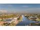 An aerial view showcasing the waterway, surrounding neighborhood, and various waterfront properties at 9214 Melody Cir, Port Charlotte, FL 33981