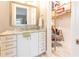 Bathroom featuring a white vanity and generous storage, with access to the walk-in shower at 9214 Melody Cir, Port Charlotte, FL 33981
