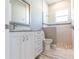 Bright bathroom featuring a marble vanity, white cabinets, and a glass-enclosed shower with decorative tile at 9214 Melody Cir, Port Charlotte, FL 33981