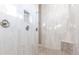 A beautifully tiled walk-in shower features dual shower heads and elegant tile design at 9214 Melody Cir, Port Charlotte, FL 33981
