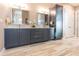 Elegant bathroom with dual sinks, granite countertops, dark wood cabinets, and ample storage at 9214 Melody Cir, Port Charlotte, FL 33981