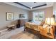 Cozy bedroom features a ceiling fan, stylish furniture, and tranquil outdoor views at 9214 Melody Cir, Port Charlotte, FL 33981