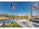 Waterfront dock featuring a flagpole with American flag, lush greenery, and tranquil water views at 9214 Melody Cir, Port Charlotte, FL 33981