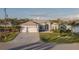 Charming one-story home with manicured lawn, stone details, and a three-car garage at 9214 Melody Cir, Port Charlotte, FL 33981