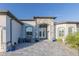 Inviting entryway with a seating area, stone accents, a double door, and mature landscaping at 9214 Melody Cir, Port Charlotte, FL 33981