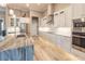 Modern kitchen features an island with marble countertops, stainless steel appliances, and a decorative tile backsplash at 9214 Melody Cir, Port Charlotte, FL 33981