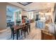 Open-concept living space with a kitchen island, dining area, and sliding glass doors at 9214 Melody Cir, Port Charlotte, FL 33981