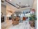 Spacious living room with high ceilings, tile floors, and a view of the outdoor living space and kitchen at 9214 Melody Cir, Port Charlotte, FL 33981