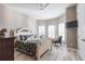 Inviting bedroom with wood floors, a ceiling fan, and a cozy sitting area by the windows at 9214 Melody Cir, Port Charlotte, FL 33981