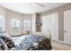 Comfortable bedroom with wood floors, large windows with shutters, and a cozy atmosphere at 9214 Melody Cir, Port Charlotte, FL 33981