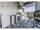 Outdoor kitchen featuring a stainless steel grill, refrigerator, and sink, perfect for outdoor entertainment at 9214 Melody Cir, Port Charlotte, FL 33981
