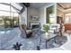 Inviting outdoor living space with fireplace, comfortable seating, and a view of the pool at 9214 Melody Cir, Port Charlotte, FL 33981