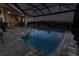 A private outdoor pool with a spacious lanai, adjacent to a convenient outdoor kitchen area at 9214 Melody Cir, Port Charlotte, FL 33981