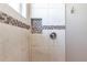 Detailed shower with decorative tile trim, a built-in niche, and modern fixtures at 9214 Melody Cir, Port Charlotte, FL 33981