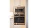 Stainless steel microwave and oven installed in a white kitchen cabinet at 9214 Melody Cir, Port Charlotte, FL 33981