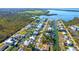 Aerial view of a waterfront home nestled in a residential neighborhood with canals and lush greenery at 9230 Pine Cove Dr, Englewood, FL 34224