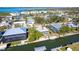 Aerial shot showing the property with waterfront access, boat docks, and lush green surroundings at 9230 Pine Cove Dr, Englewood, FL 34224