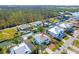 Aerial view of home featuring a canal front with boat dock, lush landscaping, and a spacious backyard at 9230 Pine Cove Dr, Englewood, FL 34224