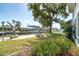 Backyard on the canal featuring a bench, mature tree, and access to boat dock at 9230 Pine Cove Dr, Englewood, FL 34224