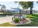 Scenic backyard view with a boat lift and waterside bench seating area at 9230 Pine Cove Dr, Englewood, FL 34224
