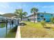 Waterfront property featuring boat lift, canal, and inviting backyard at 9230 Pine Cove Dr, Englewood, FL 34224