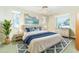 Cozy bedroom with natural light, ceiling fan, and coastal decor at 9230 Pine Cove Dr, Englewood, FL 34224