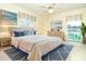 Spacious bedroom with a large bed, dresser, bedside tables, and a window view at 9230 Pine Cove Dr, Englewood, FL 34224