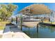 Covered boat lift ready for nautical adventures on the canal at 9230 Pine Cove Dr, Englewood, FL 34224