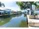 Picturesque view down the canal with boat lifts and waterfront homes at 9230 Pine Cove Dr, Englewood, FL 34224