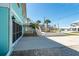 View of a spacious driveway that includes stairs that lead up to a second-story balcony and storm shutters at 9230 Pine Cove Dr, Englewood, FL 34224