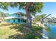 Beautiful waterfront property featuring a private dock, boat lift, and spacious lawn at 9230 Pine Cove Dr, Englewood, FL 34224