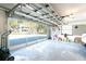 Garage interior with an open door overlooking tropical trees, a car partially visible on the right at 9230 Pine Cove Dr, Englewood, FL 34224