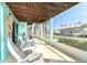 Inviting screened patio with seating, views of the canal, and boat dock at 9230 Pine Cove Dr, Englewood, FL 34224