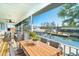 Relaxing screened porch with outdoor seating overlooking the canal and waterfront at 9230 Pine Cove Dr, Englewood, FL 34224