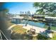 Waterfront view from the home showcasing a canal, boat lifts, docks, and the American flag at 9230 Pine Cove Dr, Englewood, FL 34224