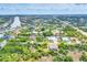 An aerial perspective captures a home amidst a lush, green landscape near serene waterways and a coastal community at 9283 Impala Cir, Port Charlotte, FL 33981