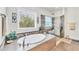 A bathroom features a standalone tub and glass shower near a window that lets in natural light at 9283 Impala Cir, Port Charlotte, FL 33981