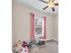 Bedroom with pink curtains and toys at 9283 Impala Cir, Port Charlotte, FL 33981