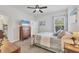 Bedroom with neutral walls and a plush bed is bathed in sunlight streaming through the window at 9283 Impala Cir, Port Charlotte, FL 33981