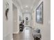 Warm and inviting foyer featuring stylish decor, tray ceiling, and tile flooring at 9283 Impala Cir, Port Charlotte, FL 33981