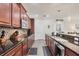 Galley kitchen boasts granite countertops, wood cabinets, stainless steel appliances and tile backsplash at 9283 Impala Cir, Port Charlotte, FL 33981