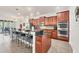 Well-equipped kitchen with island, breakfast bar, stainless appliances, and custom cabinets at 9283 Impala Cir, Port Charlotte, FL 33981