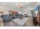 Open-concept living room with hardwood floors, ceiling fans, and modern furnishings at 9283 Impala Cir, Port Charlotte, FL 33981