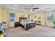Bright main bedroom with tray ceiling, sitting area, and large windows at 9283 Impala Cir, Port Charlotte, FL 33981