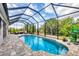 Enclosed pool area featuring a tranquil pool, lounge chair, and elegant paving at 9283 Impala Cir, Port Charlotte, FL 33981