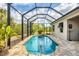 A sunny pool area with a well-maintained pool, framed by lush landscaping and a screened enclosure at 9283 Impala Cir, Port Charlotte, FL 33981