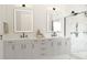 Spacious bathroom featuring double vanities, modern lighting, and a walk-in shower at Lot 18 Blk 284 Wooley Ave, North Port, FL 34287