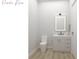 Powder room featuring a floating vanity with modern fixtures, illuminated mirror, and contemporary design at Lot 18 Blk 284 Wooley Ave, North Port, FL 34287